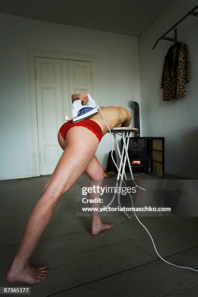 woman with electric iron - ironing board imagens e fotografias de stock