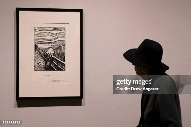 Woman observes a lithographic crayon version of "The Scream" during a preview of the Edward Munch exhibition titled "Between The Clock and The Bed,"...