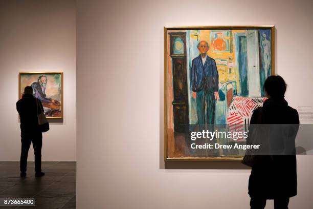 Visitors take in the self-portrait section of the Edward Munch exhibition titled "Between The Clock and The Bed," at the Met Breuer, November 13,...