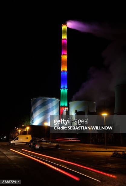 The chimney of the power plant Nord is illuminated in Chemnitz, eastern Germany on November 13, 2017. - The 300-metre high structure is decorated...