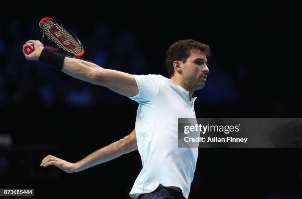 Grigor Dimitrov of Bulgaria plays a backhand in his Singles match against Dominic Thiem of Austria during day two of the Nitto ATP World Tour Finals...