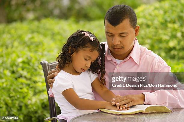 father and daughter in prayer - design pics don hammond stock-fotos und bilder