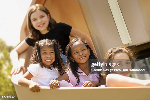 kids on a slide - design pics don hammond stock pictures, royalty-free photos & images