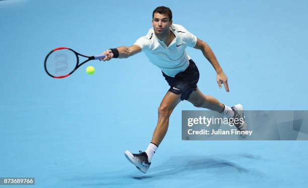 Grigor Dimitrov of Bulgaria plays a forehand in his Singles match against Dominic Thiem of Austria during day two of the Nitto ATP World Tour Finals...