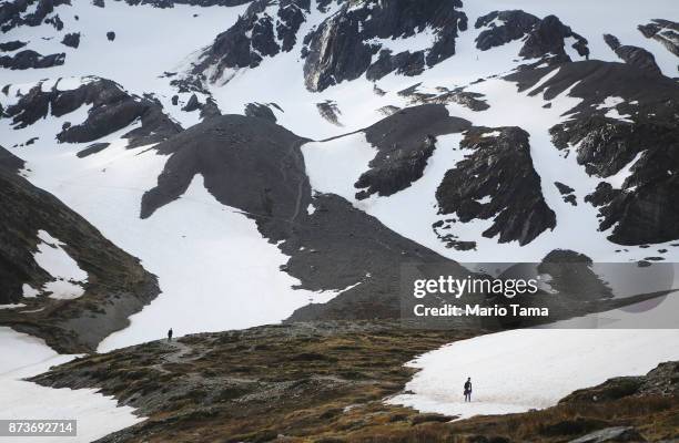 People walk at the retreating Martial Glacier on November 9, 2017 in Ushuaia, Argentina. Ushuaia is situated along the southern edge of Tierra del...