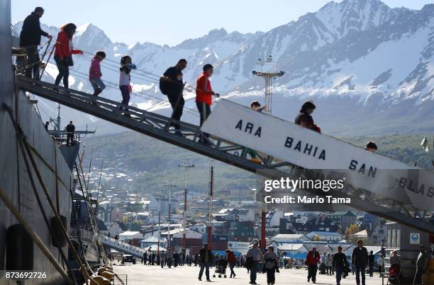 Visitors descend a Navy destroyer docked for visitor tours on November 5, 2017 in Ushuaia, Argentina. Ushuaia is situated along the southern edge of...