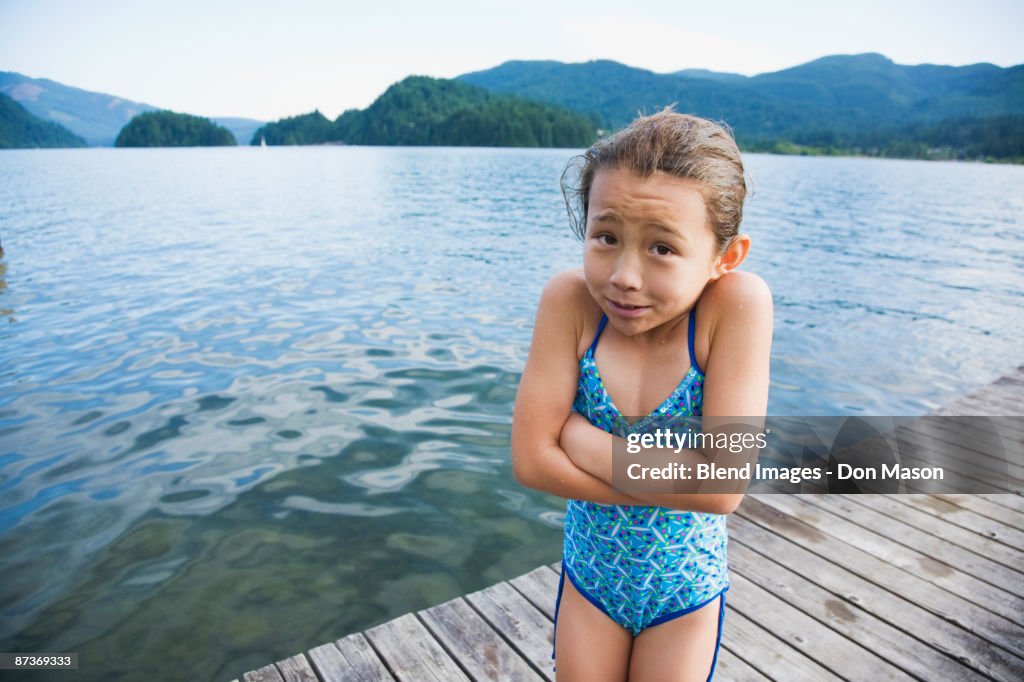 Cold Asian girl standing on dock