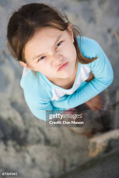 angry asian girl frowning - tegendraads stockfoto's en -beelden