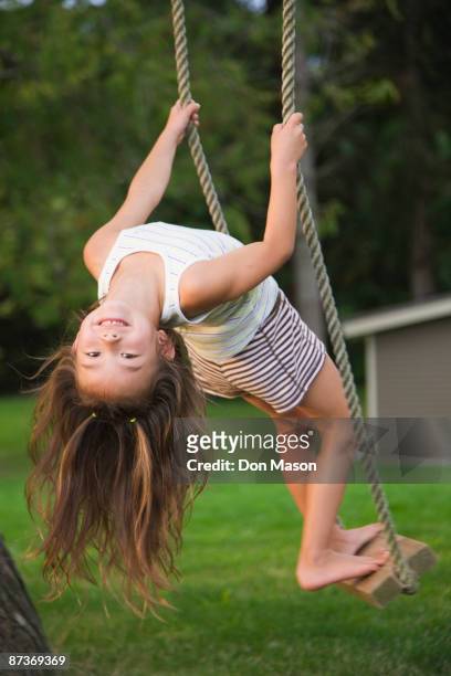 asian girl swinging on rope swing - upside down ストックフォトと画像