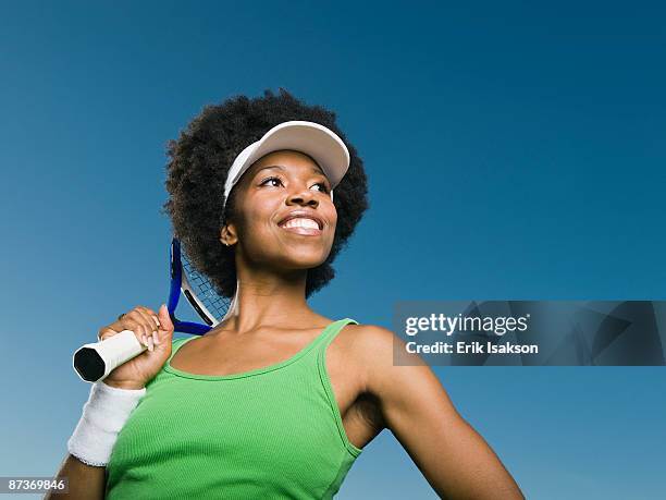 african woman holding tennis racquet - blue tennis racket stock pictures, royalty-free photos & images