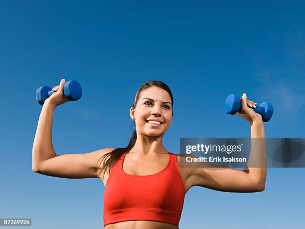 native american woman lifting hand weights - indian american woman stock pictures, royalty-free photos & images