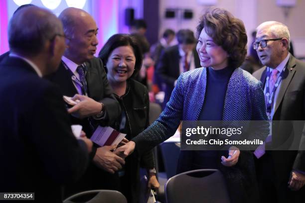 Transportation Secretary Elaine Chao greets fellow officials before delivering keynote remarks during the U.S.-Japan Council's annual conference at...