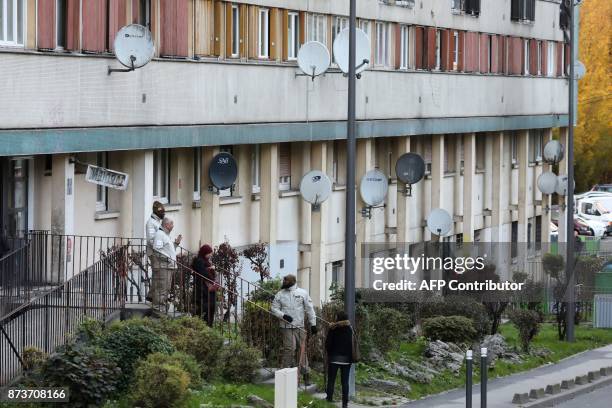 Members of the "Prevention, Public safety and Tranquility" service of Clichy-sous-Bois work on November 13 at the entrance of an apartment building,...