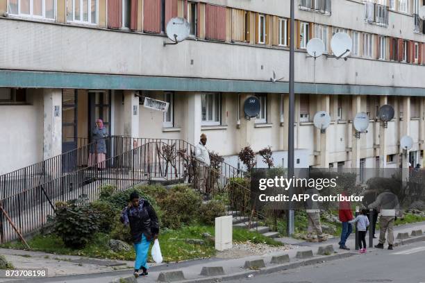 Members of the "Prevention, Public safety and Tranquility" service of Clichy-sous-Bois work on November 13 at the entrance of an apartment building,...
