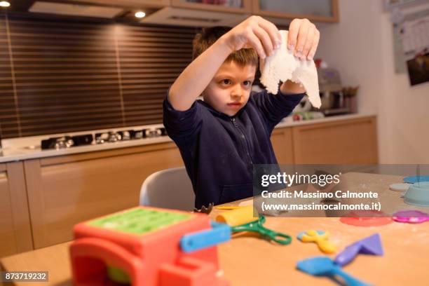 child (7 years) plays with salt dough - boys only caucasian ethnicity 6 7 years stock-fotos und bilder