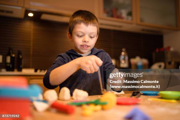 child (7 years) plays with salt dough - boys only caucasian ethnicity 6 7 years stock-fotos und bilder