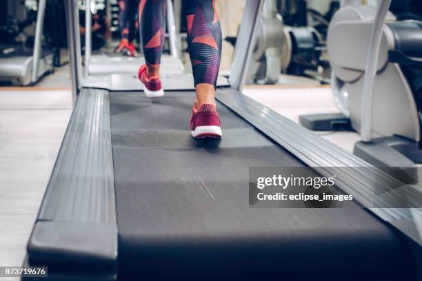 close up of women while walking on machine - running spikes stock pictures, royalty-free photos & images