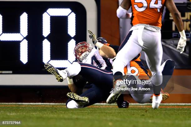 Rex Burkhead of the New England Patriots tackles in the end zone by Darian Stewart of the Denver Broncos for a touchdown during the first quarter on...