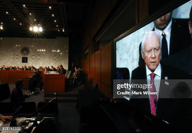 Chairman Orrin Hatch , is shown on a monitor speaking during a Senate Finance Committee markup of the Tax Cuts and Jobs Act legislation on Capitol...