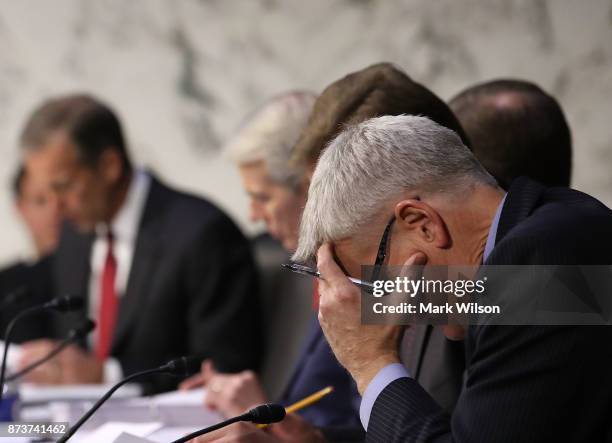 Sen. Bill Cassidy , reads his papers during a Senate Finance Committee markup of the Tax Cuts and Jobs Act legislation on Capitol Hill, November 13,...