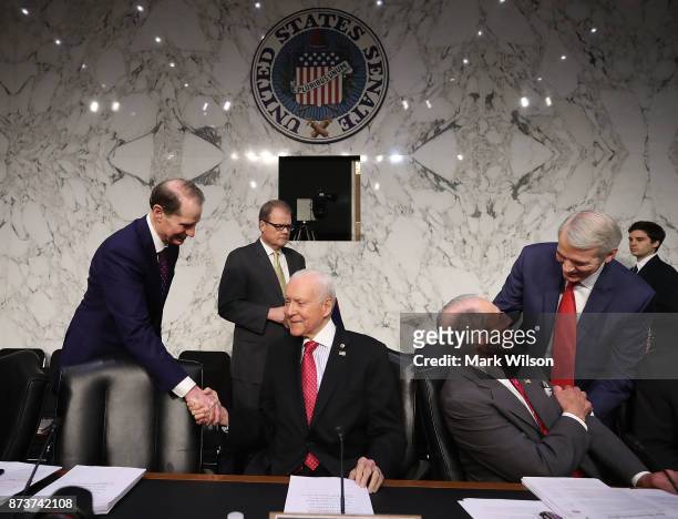 Chairman Orrin Hatch , is greeted by Sen. Ron Wyden , while Sen. Rob Portman greets Sen. Chuck Grassley , during a Senate Finance Committee markup of...