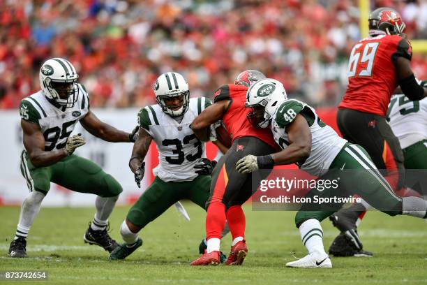 New York Jets safety Jamal Adams and New York Jets linebacker Jordan Jenkins tackle Tampa Bay Buccaneers running back Doug Martin during the second...