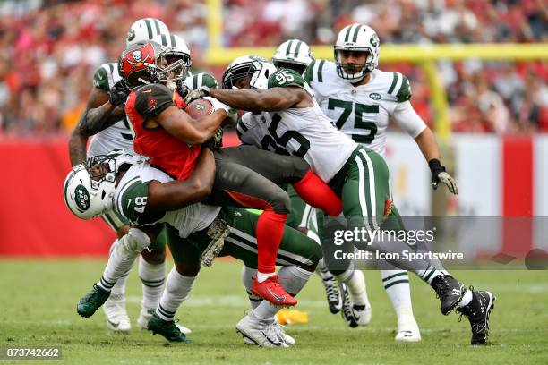 New York Jets linebacker Jordan Jenkins lifts Tampa Bay Buccaneers running back Doug Martin off the ground and slams him to the turf during the...