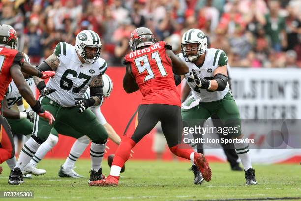 New York Jets guard Brian Winters and New York Jets center Wesley Johnson double team Tampa Bay Buccaneers defensive end Robert Ayers Jr. During the...