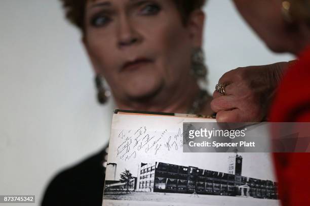 Beverly Young Nelson holds her high school yearbook signed by Roy Moore during a news conference where she has accused Alabama Republican Senate...