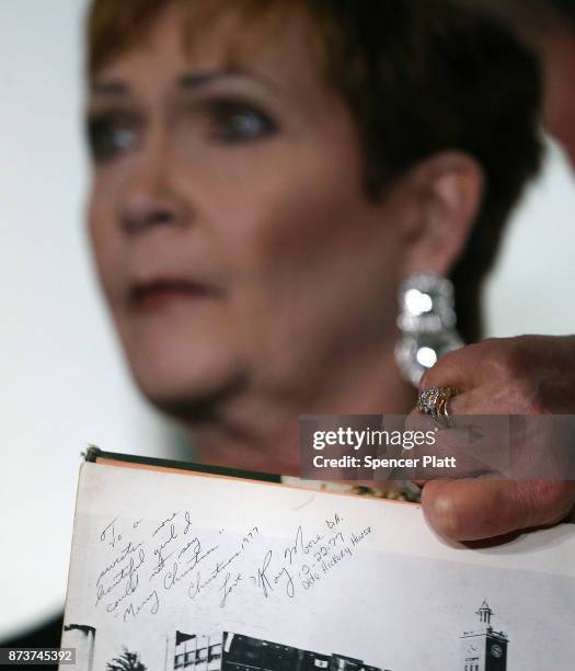 Beverly Young Nelson holds her high school yearbook signed by Roy Moore during a news conference where she has accused Alabama Republican Senate...