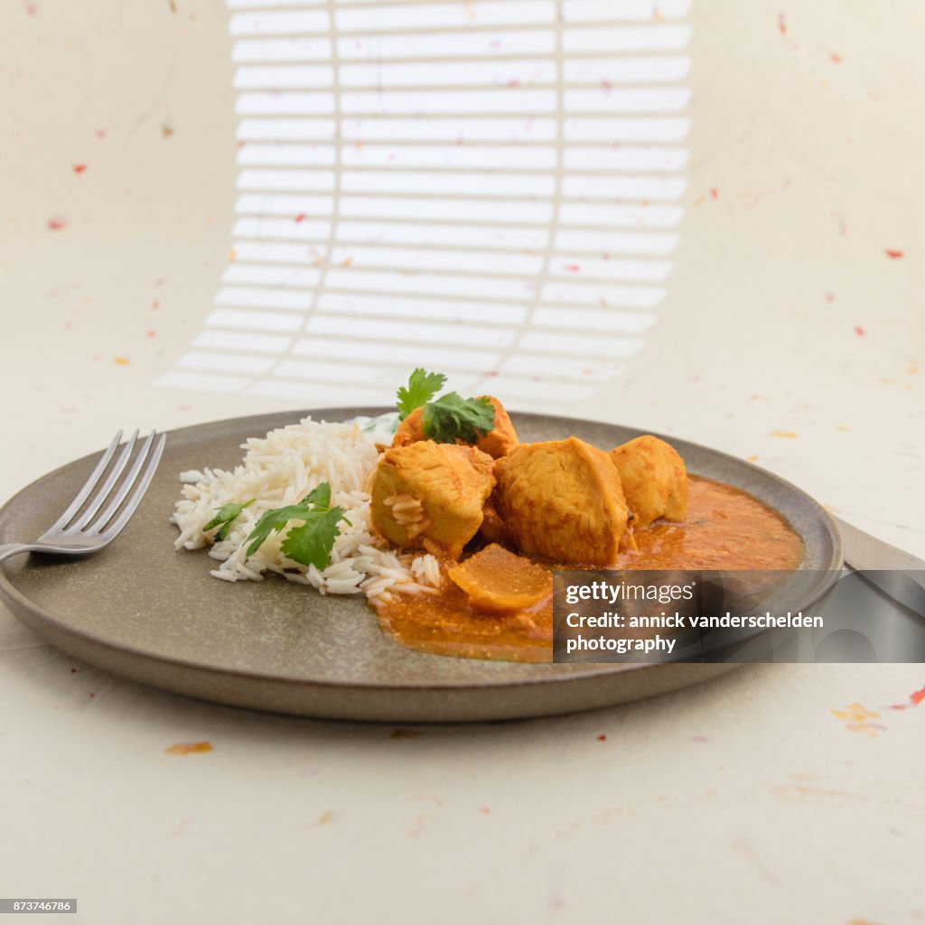 Chicken curry, rice and yoghurt-cilantro mixture.