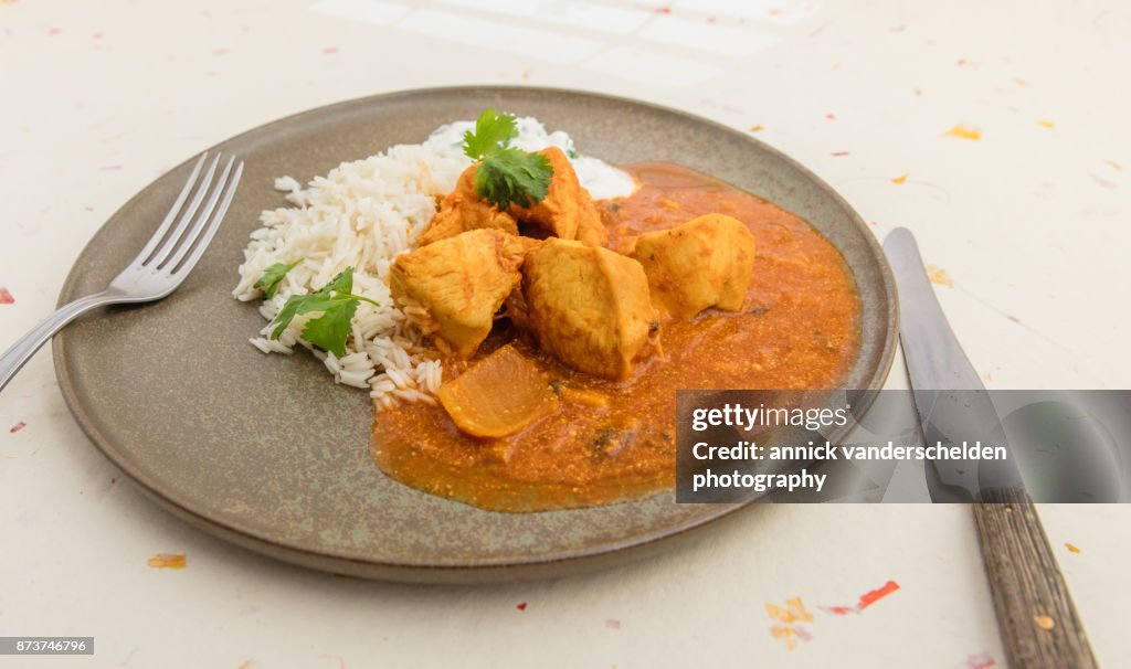 Chicken curry, rice and yoghurt-cilantro mixture.