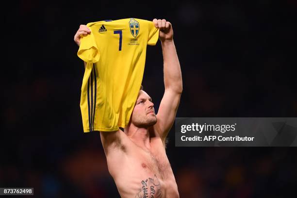 Sweden's midfielder Sebastian Larsson celebrates at the end of the FIFA World Cup 2018 qualification football match between Italy and Sweden, on...