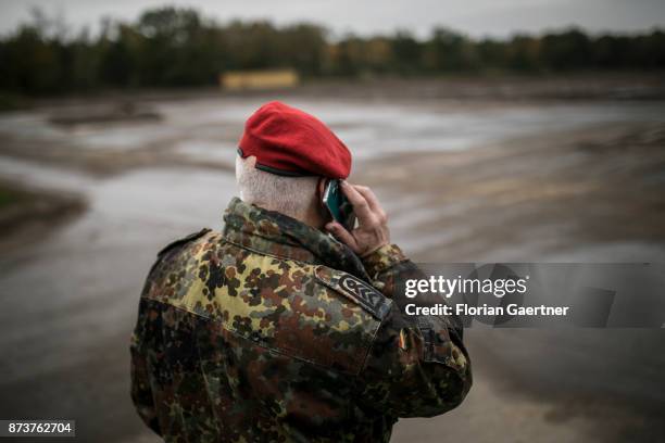 Soldier is talking on a mobile phone. Shot during an exercise of the land forces on October 13, 2017 in Munster, Germany.