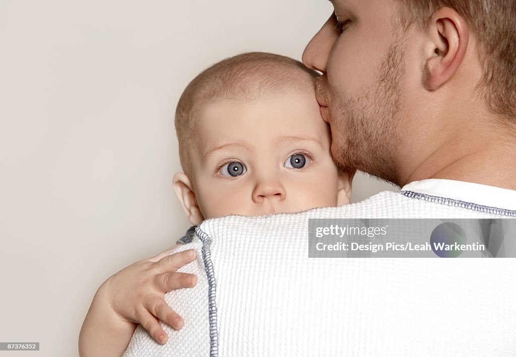 Father kissing a baby boy