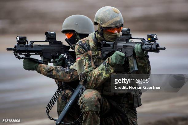 Two masked soldiers from the detail of electronic warfare with ready to fire guns. Shot during an exercise of the land forces on October 13, 2017 in...