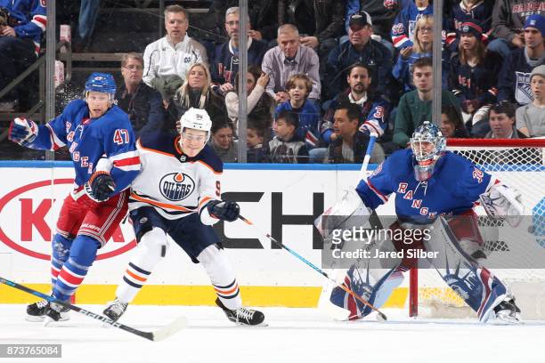 Henrik Lundqvist of the New York Rangers tends the net as Steven Kampfer defends against Jesse Puljujarvi of the Edmonton Oilers at Madison Square...