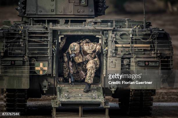 Soldier with equipment 'Infantryman of the future - extended system leaves the tank 'Puma'. Shot during an exercise of the land forces on October 13,...