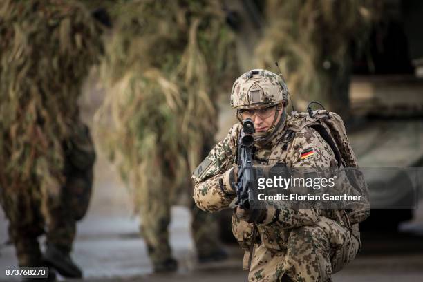 Soldier with equipment 'Infantryman of the Future - Extended System and ready to fire gun. Snipers with camouflage in the so-called Ghillie suit are...