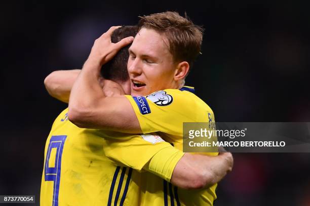Sweden's forward Marcus Berg and Sweden's midfielder Markus Rohden celebrate at the end of the FIFA World Cup 2018 qualification football match...