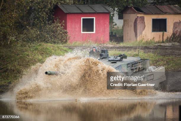 Main battle tank 'Leopard2' drives into a moat. Shot during an exercise of the land forces on October 13, 2017 in Munster, Germany.