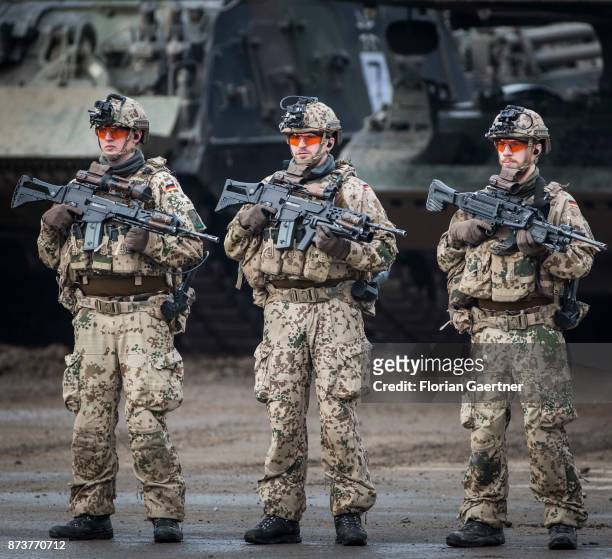 Three soldiers with equipment 'Infantryman of the Future - Extended System and rifles. Shot during an exercise of the land forces on October 13, 2017...
