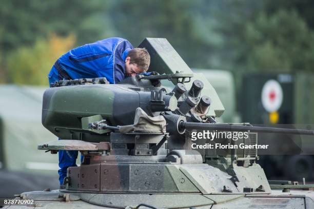 Mechanic of the German Bundeswehr repairs a tank. Shot during an exercise of the land forces on October 13, 2017 in Munster, Germany.