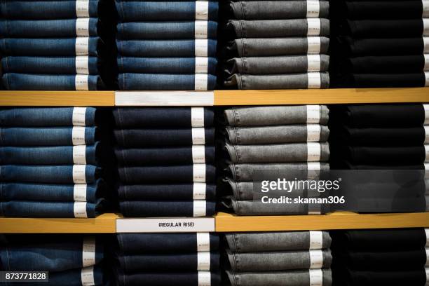 vintage denim jeans stack on shelves - denim store stock pictures, royalty-free photos & images
