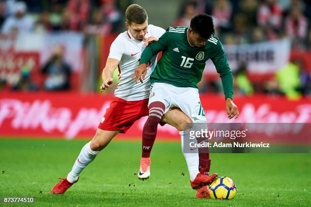 Jakub Swierczok from Poland fights for the ball with Jesus Gallardo from Mexico during the Poland v Mexico International Friendly soccer match at...