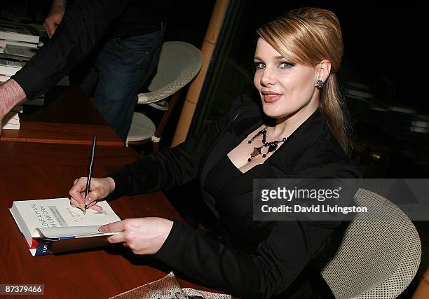 Author Lily Burana signs her book "I Love a Man in Uniform" at the "Operation Bombshell" benefit event at Trader Vic's on May 15, 2009 in Los...