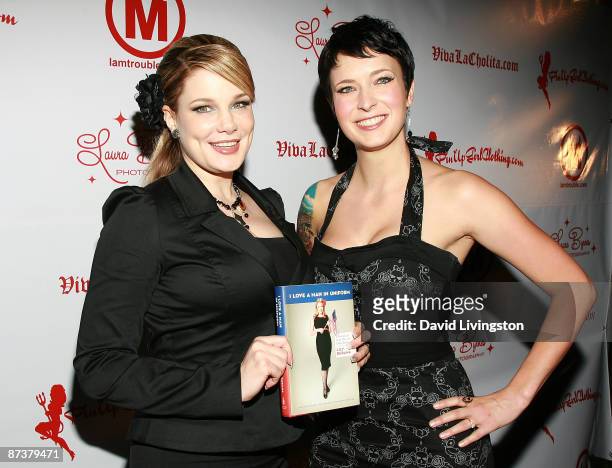 Writers Lily Burana and Diablo Cody pose with Burana's book "I Love a Man in Uniform" at the "Operation Bombshell" benefit event at Trader Vic's on...