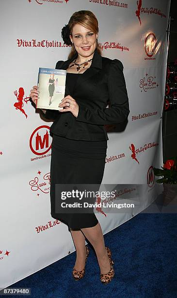 Author Lily Burana poses with her book "I Love a Man in Uniform" at the "Operation Bombshell" benefit event at Trader Vic's on May 15, 2009 in Los...