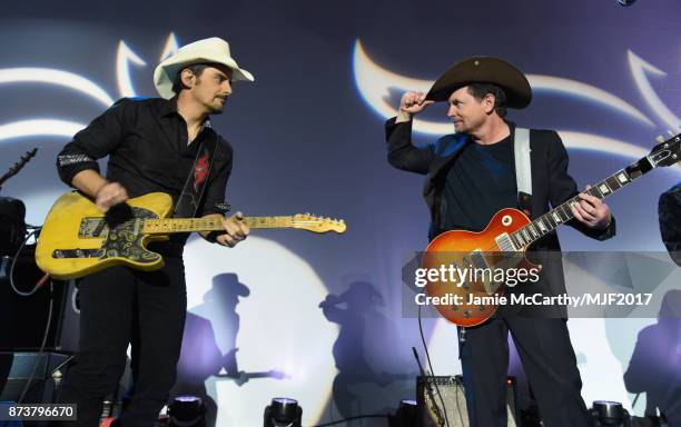 Brad Paisley and Michael J. Fox perform on stage at A Funny Thing Happened On The Way To Cure Parkinson's benefitting The Michael J. Fox Foundation...