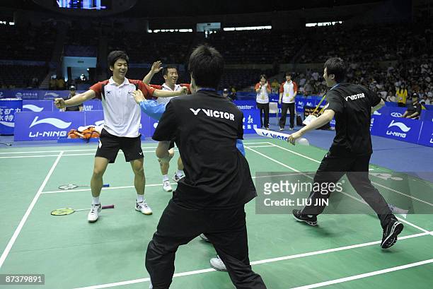 South Korea's Lee Yong Dae and Jung Jae Sung celebrate with teammates after winning over Indonesia's Hendra Setiawan and Mohammad Ahsan during the...